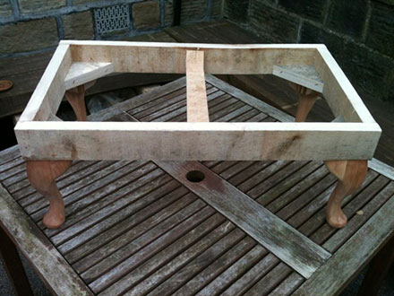 photograph of foot stool with out upholstery, basic frame